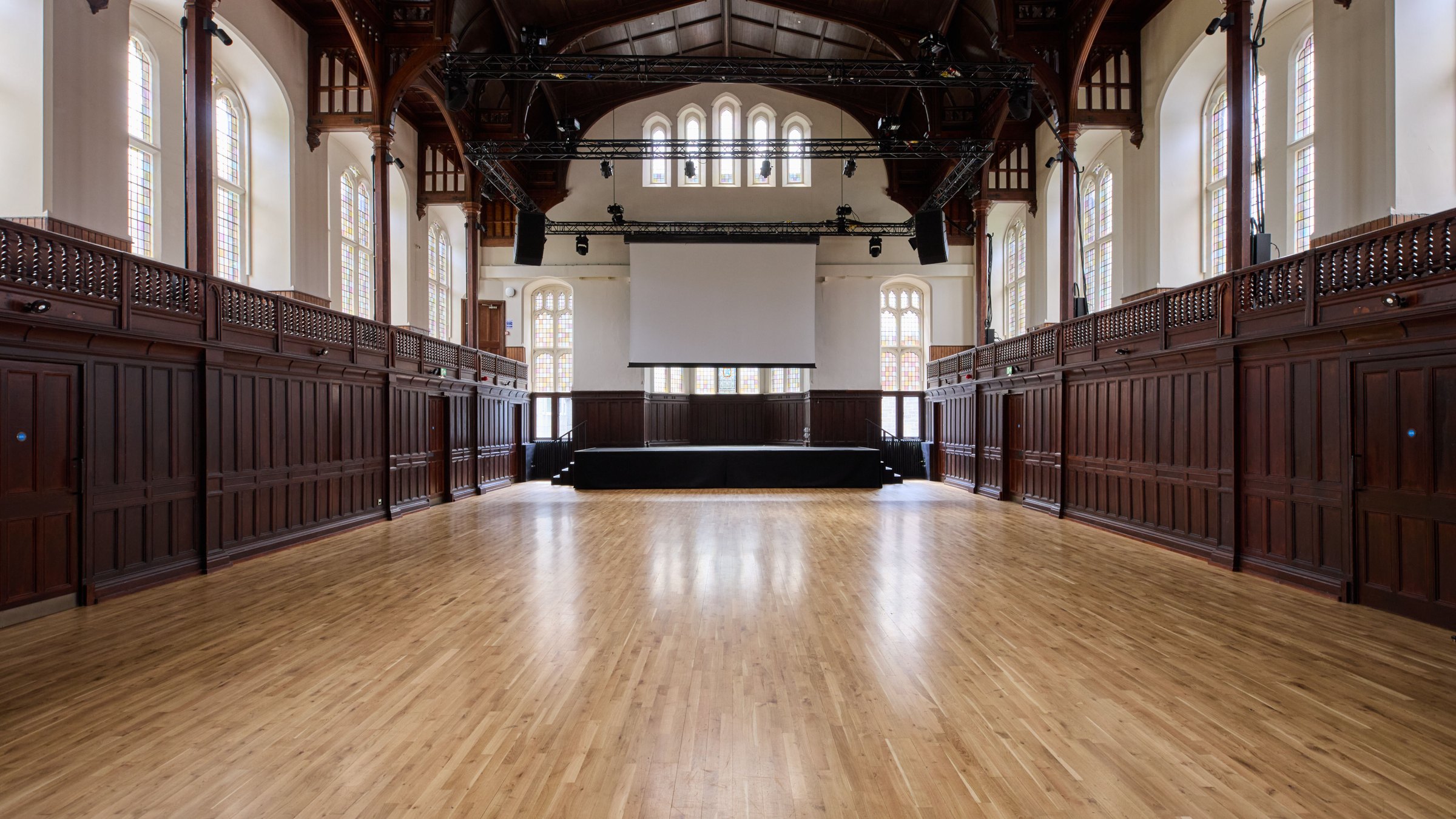 The Debating Hall at Teviot, empty, looking down the floor toward the stage