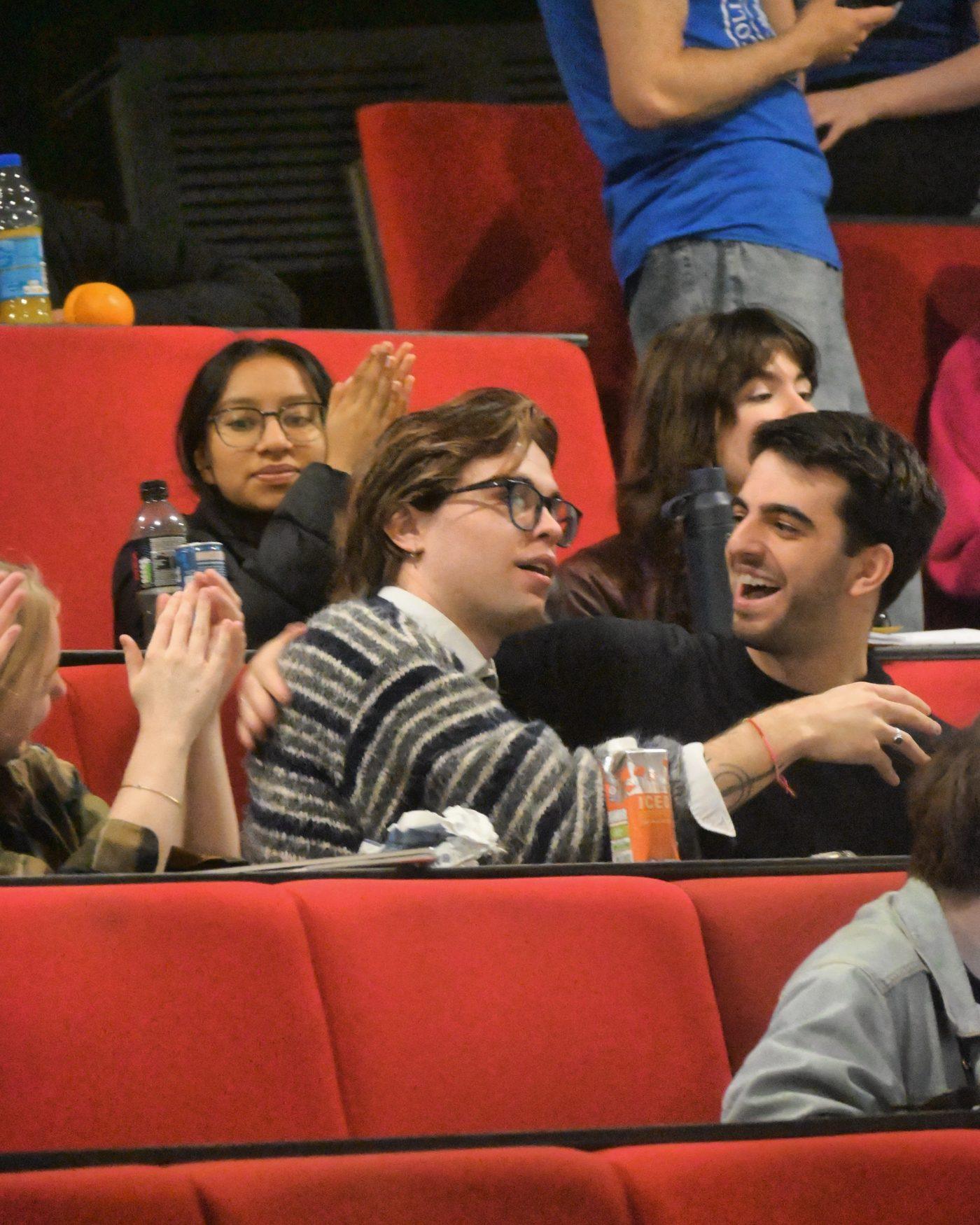 Members laughing in the seats between rounds