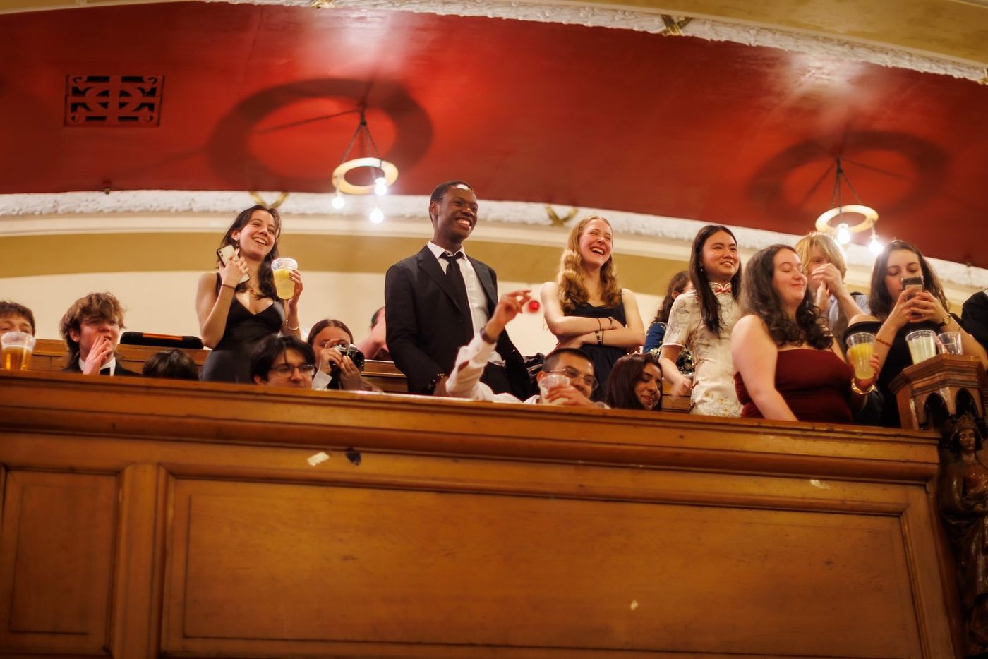 Members leaning over the gallery rail during a union night